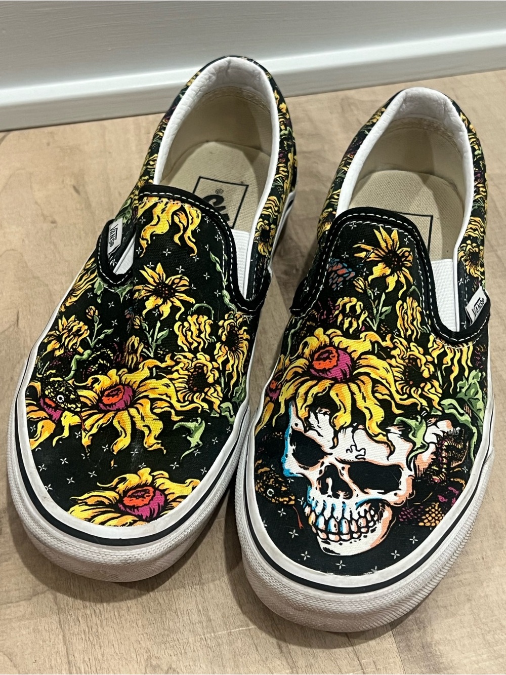 Vans Black Slip-On Sneakers with Yellow Floral Skull Artwork
